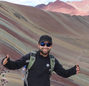 Joel Callanpuna Joel poses by the rainbow mountains.