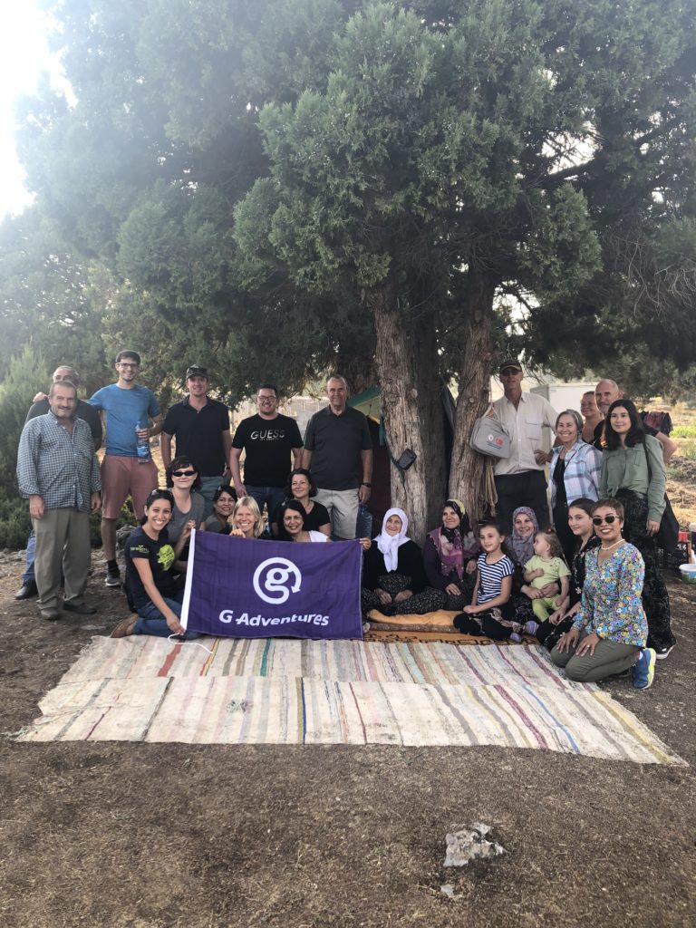 A group of G Adventures’ travellers enjoying the Almond Park and getting to know the locals.